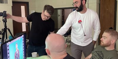The Deafverse team discusses how to finetune the camera angle and lighting while Justin P. waits for feedback on his signing.