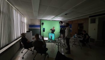 Justin narrates and acts out a scene while the rest of the Deafverse team looks on.